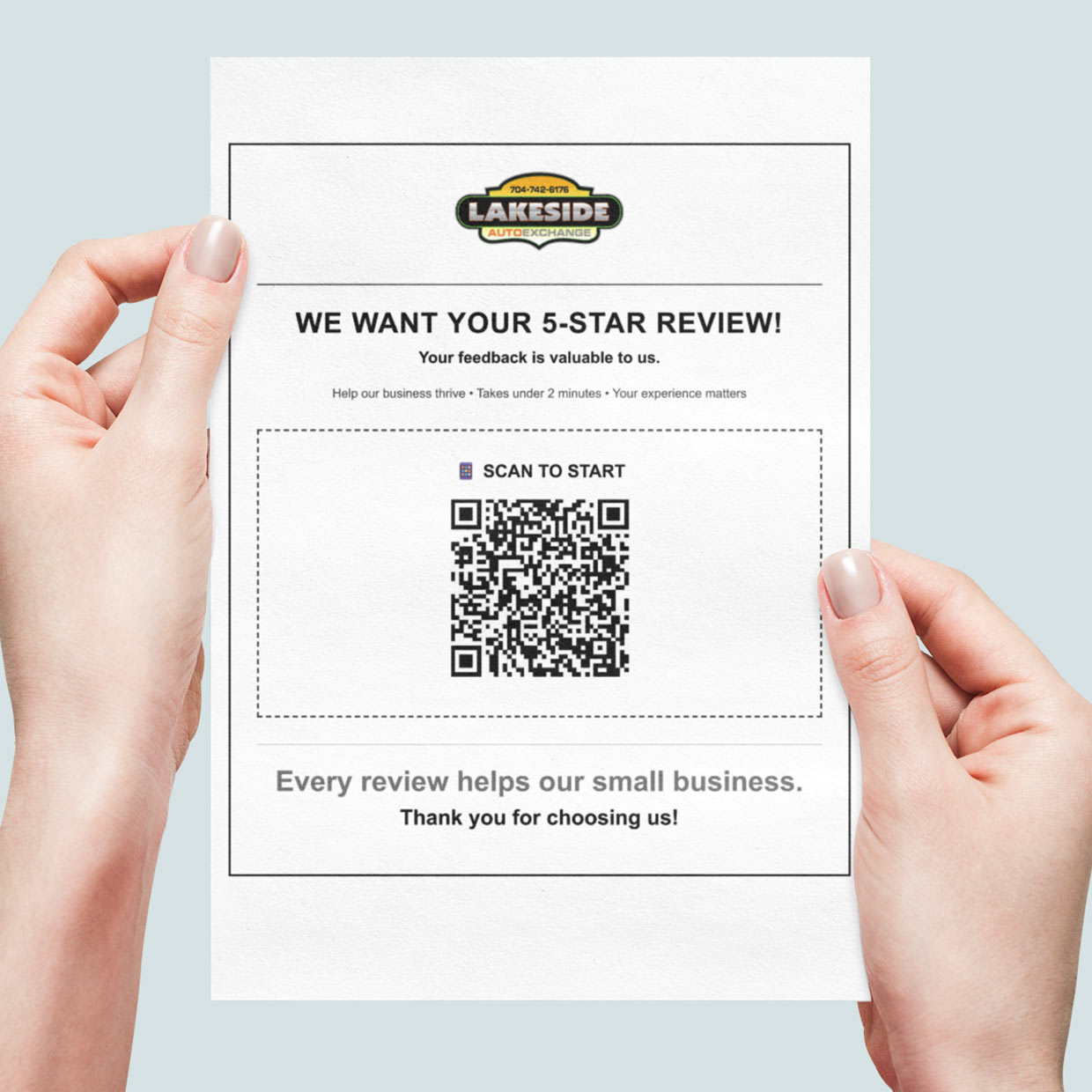 Business owner holding a custom printed review handout with QR code